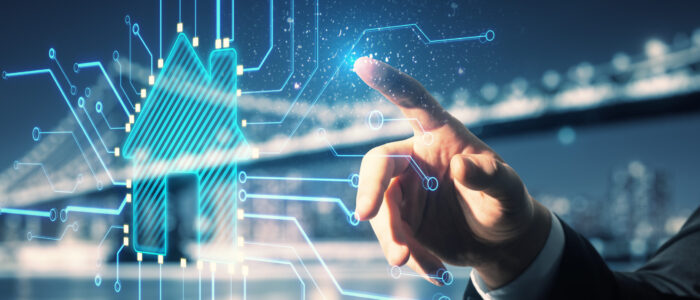 Close up of businessman hand pointing at abstract glowing house chip hologram on blurry night city background. Smart home, ai and information concept. Double exposure